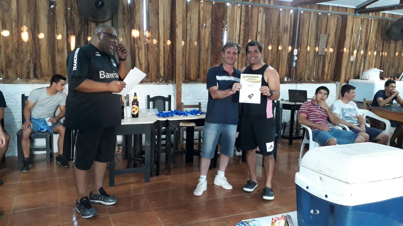 tres atletas abraçados